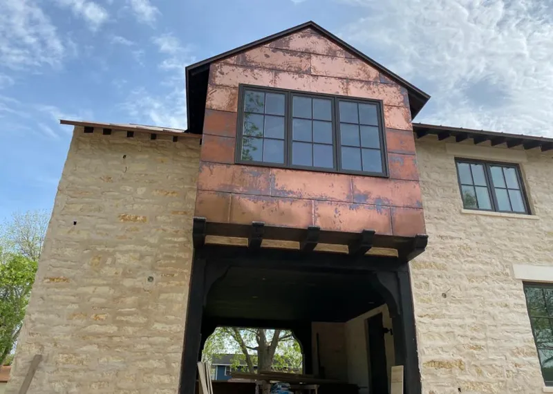 Copper metal panel facade on a stone building for Skylight Installation in Shawnee