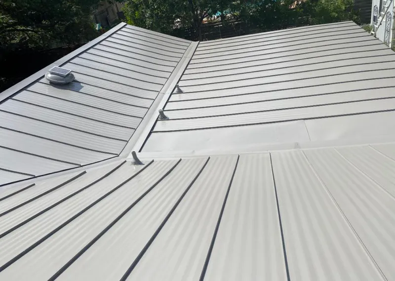 Solar attic fan installed on a metal roof for Roof Ventilation in Shawnee